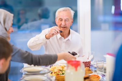 Residents enjoying a meal together at a dining table