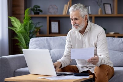 Senior man using a laptop at home