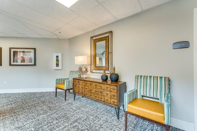 Salon area with chairs and decorative mirror