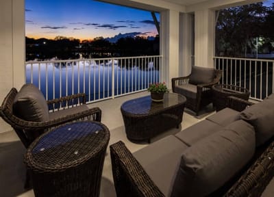 Outdoor seating area with a view of the lake at sunset