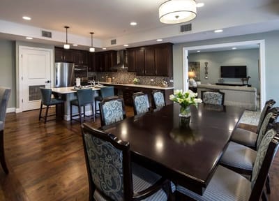 Bright dining area with a large table and kitchen