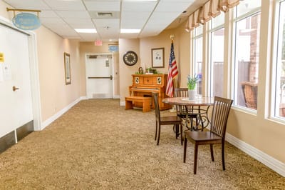 Interior hallway with a piano and seating area