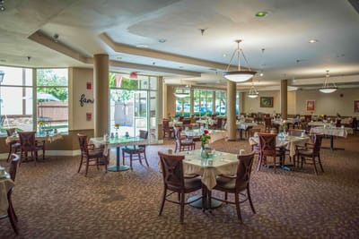 Dining area with tables set for residents