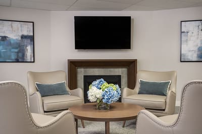 Cozy common area with comfortable seating and floral centerpiece