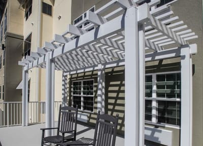 Outdoor seating area with a pergola and rocking chairs