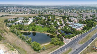 Aerial view of The Villas at Sunny Acres with gardens and ponds