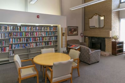 Interior view of a library common area with bookshelves and seating