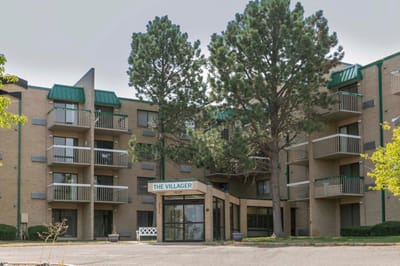 Exterior view of The Villager facility with green accents