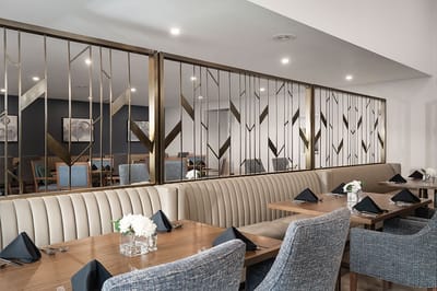 A dining area with elegant seating and table settings.