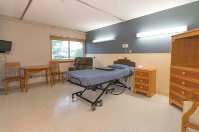 A resident room with bed and furniture