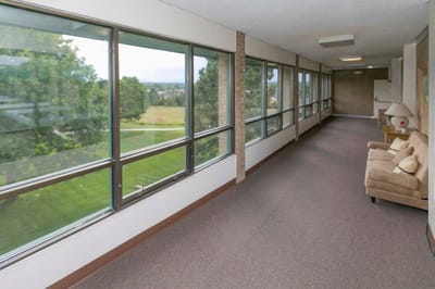 Bright corridor with large windows and seating area