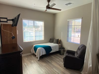 A cozy resident room with natural light and amenities