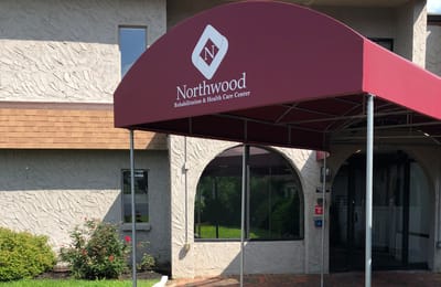 Entrance with facility logo and awning