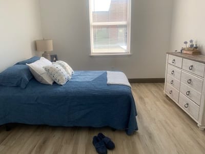 A well-furnished private bedroom in a facility