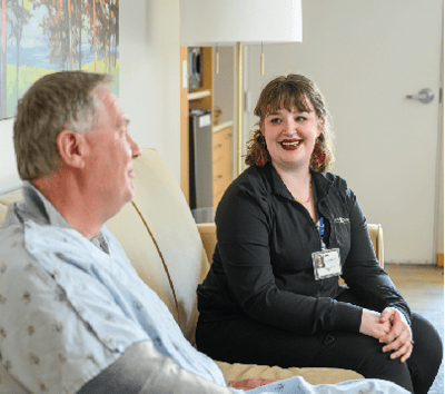 Staff member talking with a resident in a casual setting