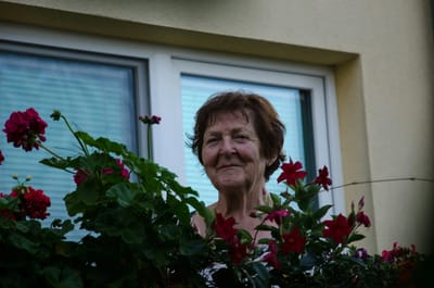 Resident enjoying flowers on a balcony