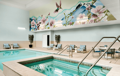 Interior view of a pool area with artistic mural
