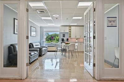 Bright common area with seating and a coffee bar