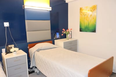 A cozy resident room with a bed and decor