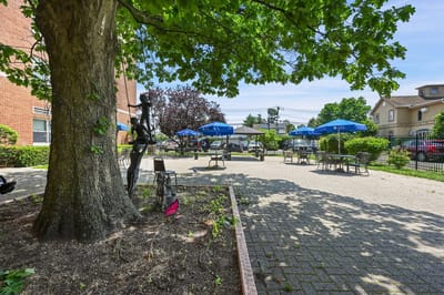 Outdoor seating area with umbrellas and landscaping