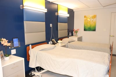 A shared resident room with two beds and decor