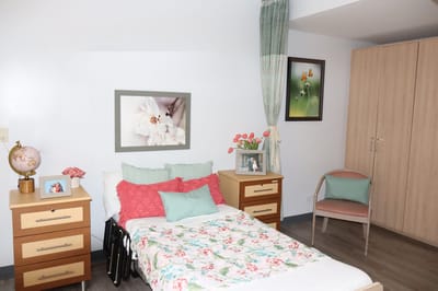 Cozy resident room with floral bedding and decor