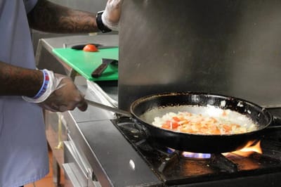 A staff member cooking in the kitchen