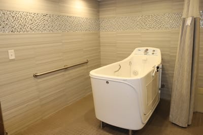 Therapeutic bathing tub in a tiled bathroom