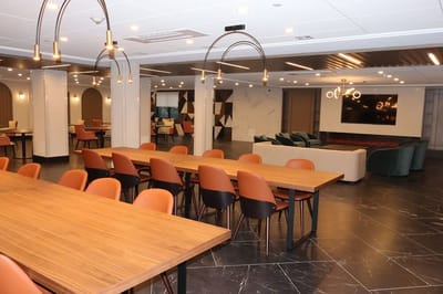 Bright interior common area with tables and chairs