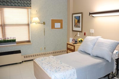 A resident room with a bed and window light