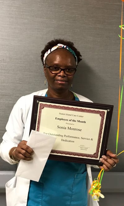 Employee of the Month holding a certificate