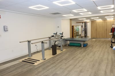 A rehabilitation gym area with equipment and exercise space