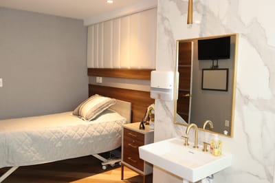 Cozy private resident room with a bed and sink