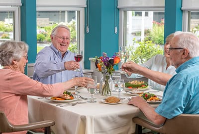 Residents enjoying a meal together in the dining room