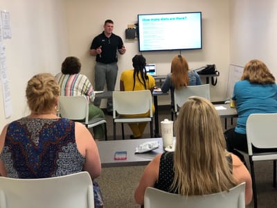 Residents attending a nutrition class in a meeting room