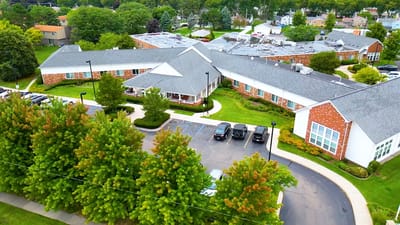 Aerial view of Medilodge of Monroe showing the facility and parking area