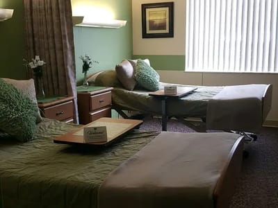 Brightly decorated shared resident room with beds and welcome signs