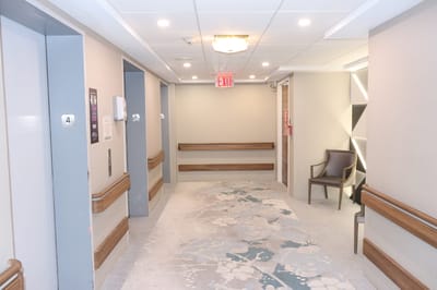 Interior hallway with elevators and seating area