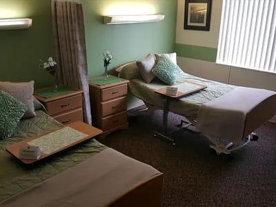 A shared resident room with two beds and nightstands