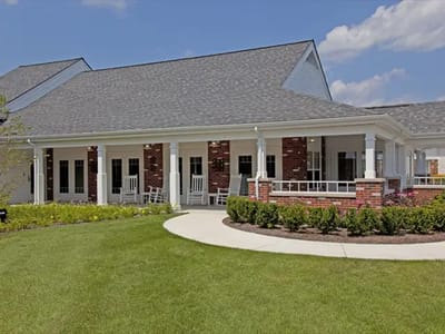 Exterior view of a senior living facility with garden.