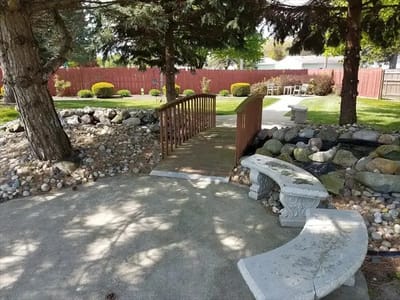 A serene outdoor space with a bridge and benches