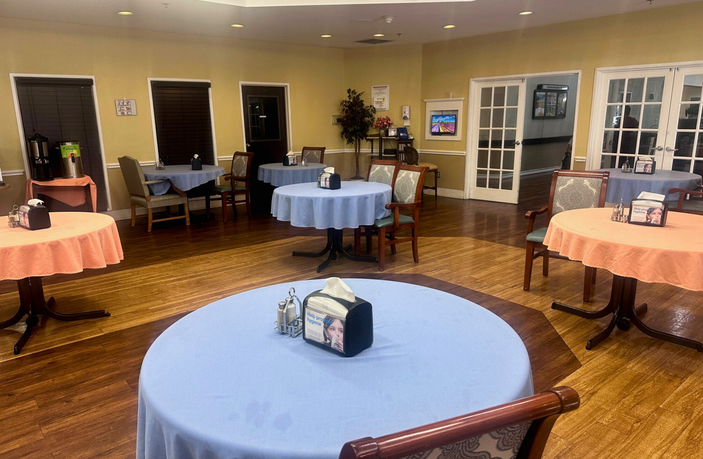 Dining area with tables set for residents