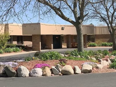 Exterior view of Medilodge of Mt Pleasant with landscaped garden.