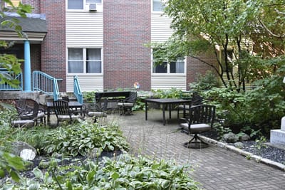 Outdoor seating area with garden at the facility