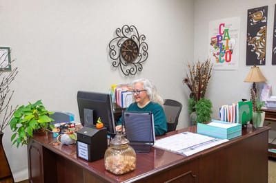 Staff member working at a reception desk