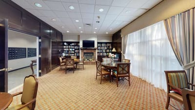 Bright common area with seating and bookshelves