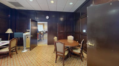 A quiet interior room with a round table and chairs