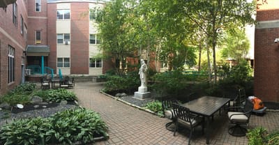 Outdoor garden area with seating and greenery