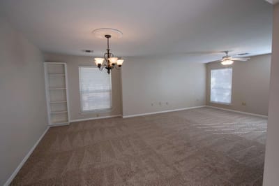 Empty interior room with carpet and lighting fixtures