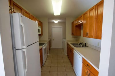 Interior view of a kitchen space with cabinets and appliances